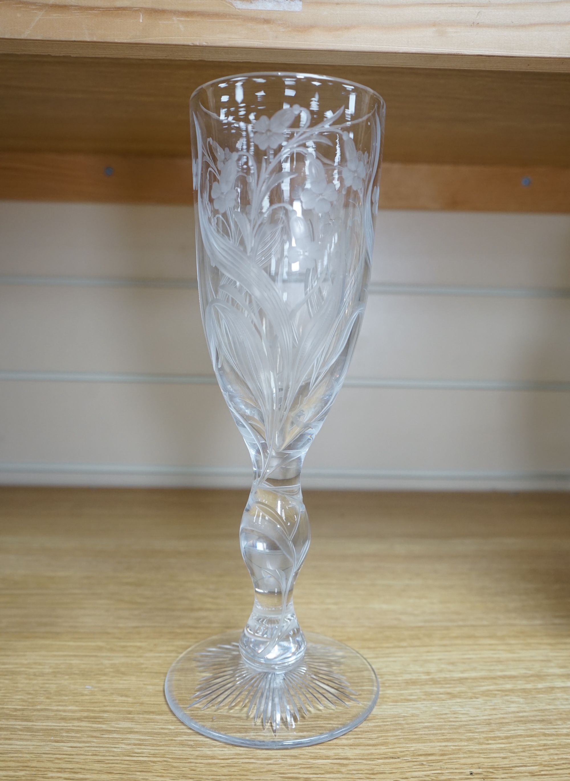 A large ‘floral’ engraved glass flute, 29.5cm. Condition - chip to upper rim